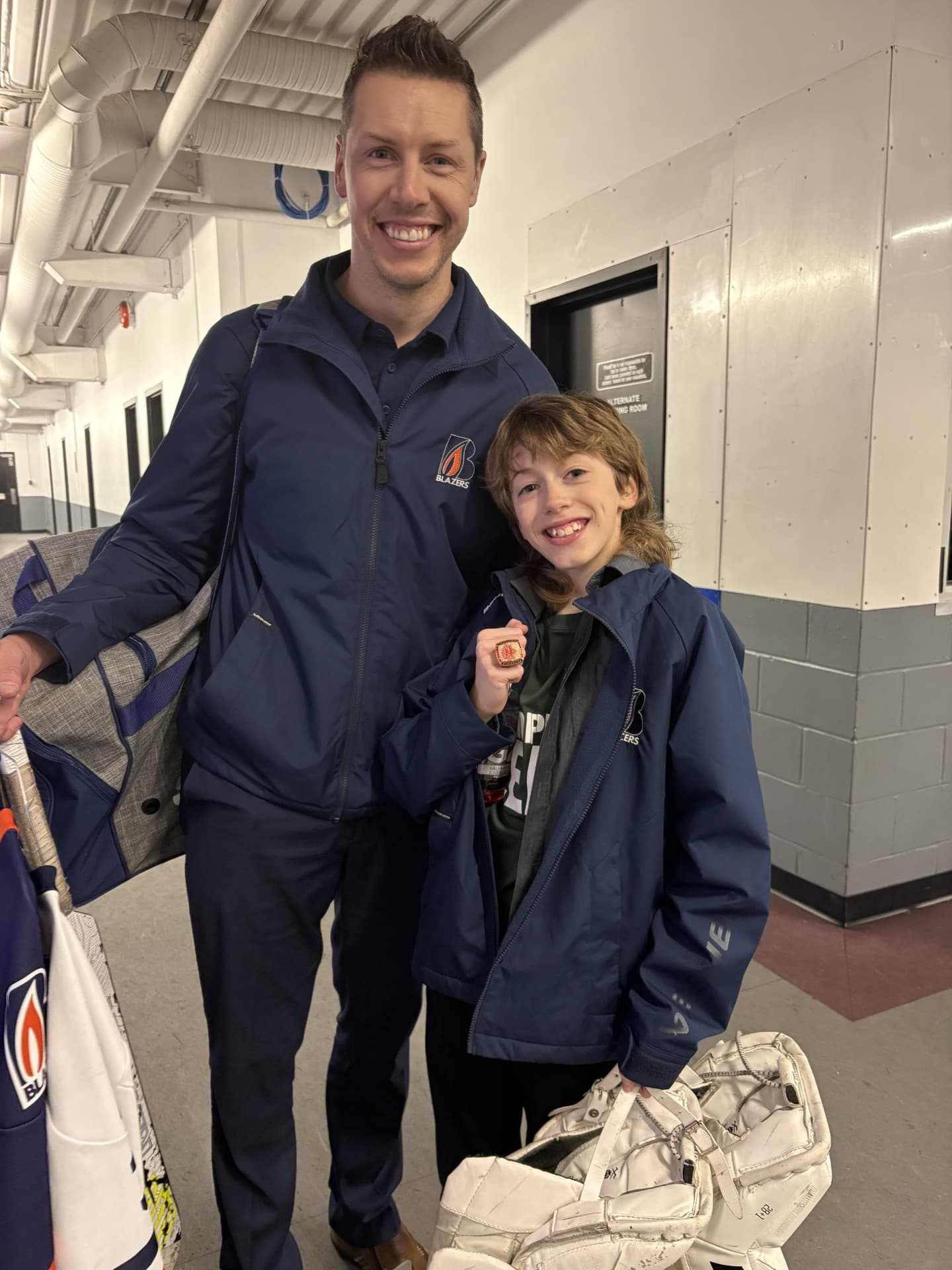 Craig Reimche and his son after a Junior Blazers game